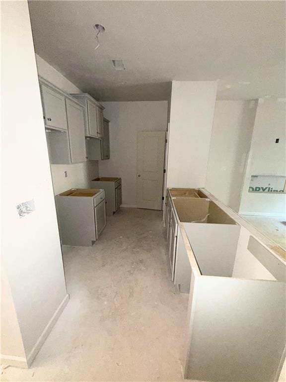 543 Courthouse Park Dr, Temple, GA 30179 - kitchen featuring gray cabinets and concrete floors