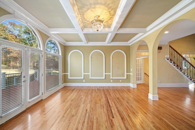 unfurnished sunroom featuring beamed ceiling, a chandelier, and coffered ceiling