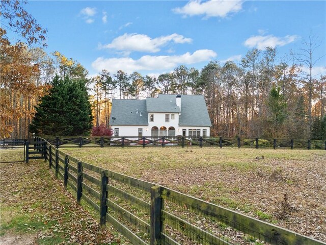 exterior space with a rural view and a front yard