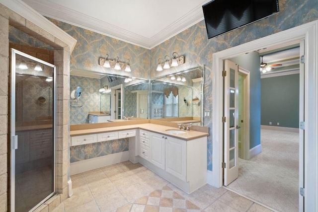 bathroom with ceiling fan, tile patterned flooring, vanity, a shower with shower door, and ornamental molding