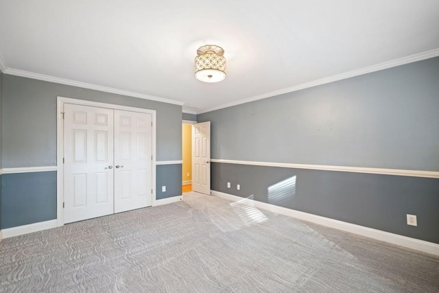 unfurnished bedroom featuring carpet flooring, a closet, and ornamental molding