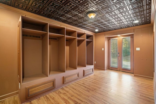 mudroom with wood-type flooring, french doors, and crown molding