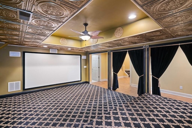 home theater featuring light colored carpet and ceiling fan