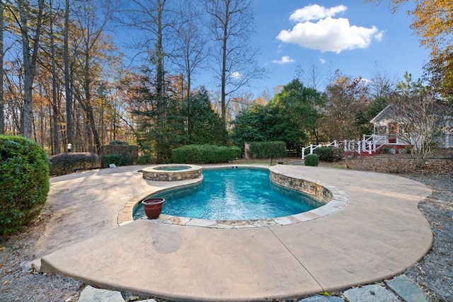 view of swimming pool featuring an in ground hot tub