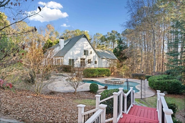 view of pool with an in ground hot tub