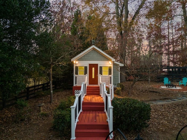 bungalow-style house with covered porch and an outdoor fire pit