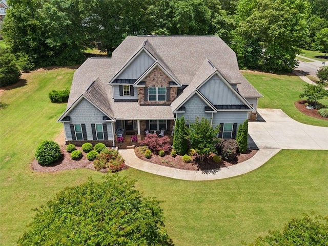 161 Archstone Sq, Mcdonough, GA 30253 - craftsman-style house featuring board and batten siding, a front yard, stone siding, a shingled roof, and covered porch