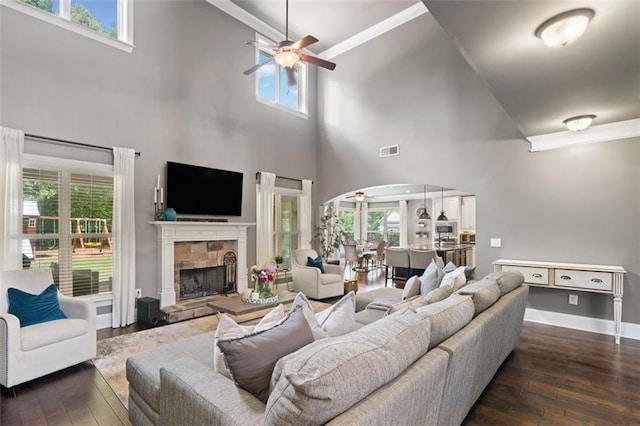 161 Archstone Sq, Mcdonough, GA 30253 - living area featuring arched walkways, a towering ceiling, ceiling fan, hardwood / wood-style floors, and crown molding