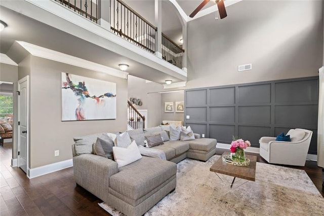 161 Archstone Sq, Mcdonough, GA 30253 - living room featuring a decorative wall, a ceiling fan, wood finished floors, a high ceiling, and ornamental molding