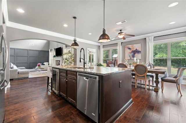 161 Archstone Sq, Mcdonough, GA 30253 - kitchen with appliances with stainless steel finishes, wine cooler, open floor plan, dark brown cabinets, and a sink