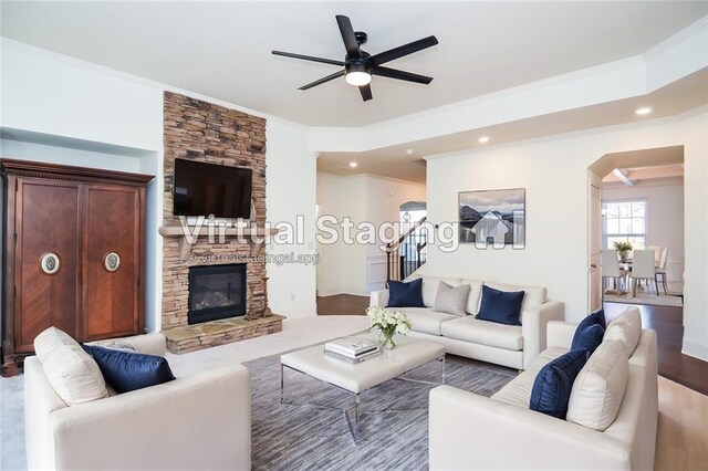 living room with ceiling fan with notable chandelier and dark wood-type flooring