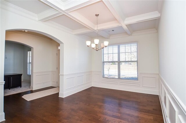 living room with an inviting chandelier, ornamental molding, and dark wood-type flooring