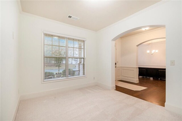 unfurnished dining area featuring an inviting chandelier, beamed ceiling, ornamental molding, coffered ceiling, and dark wood-type flooring