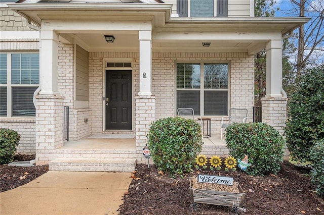 view of exterior entry with covered porch