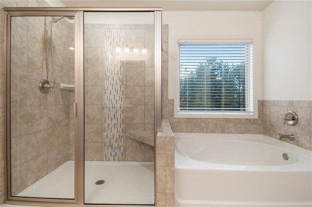 bathroom with separate shower and tub