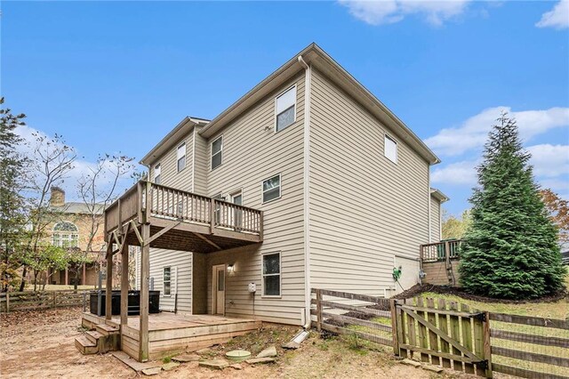 back of house featuring a wooden deck