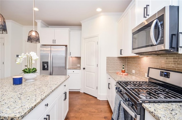 kitchen with white cabinetry, pendant lighting, light stone counters, and appliances with stainless steel finishes