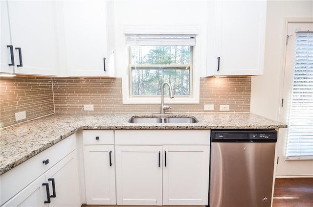 kitchen with sink, white cabinets, dishwasher, and light stone countertops