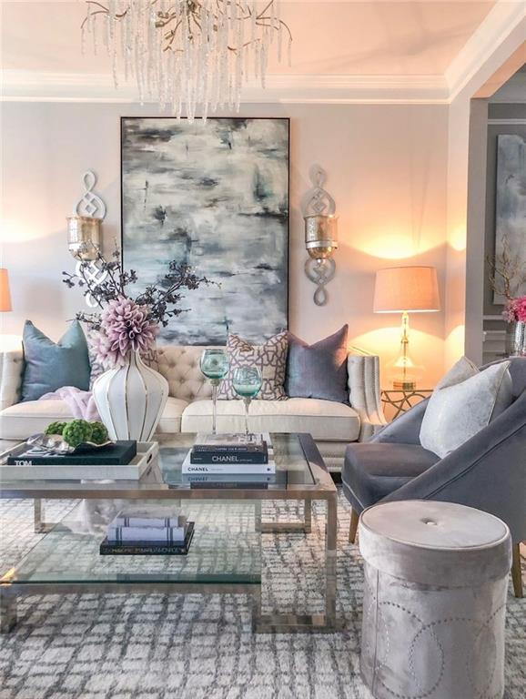 living room with a notable chandelier and ornamental molding