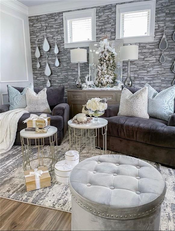 living room featuring ornamental molding, a healthy amount of sunlight, and hardwood / wood-style flooring