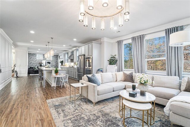 living room featuring dark hardwood / wood-style flooring and ornamental molding