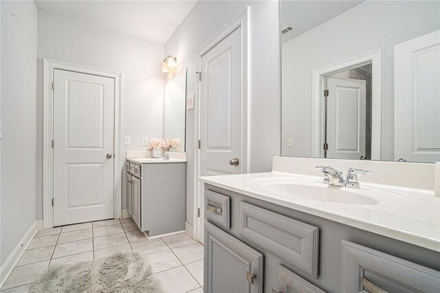 bathroom with tile patterned floors and vanity