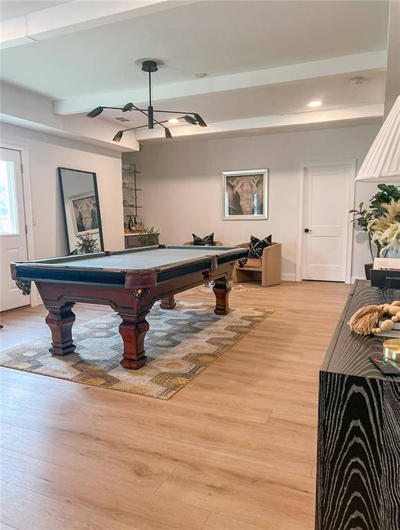 playroom with beamed ceiling, billiards, and light hardwood / wood-style flooring