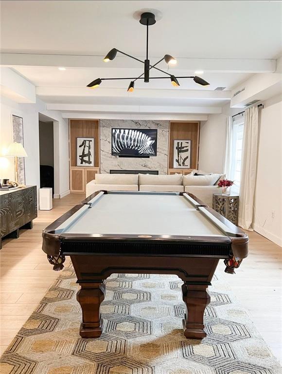 recreation room featuring beamed ceiling, light wood-type flooring, and billiards