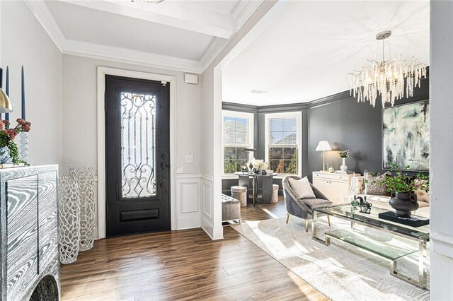 entryway with crown molding, beamed ceiling, dark hardwood / wood-style floors, and an inviting chandelier