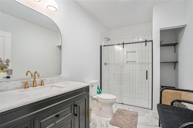 bathroom featuring walk in shower, vanity, and toilet