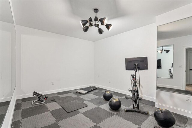 exercise room with a chandelier