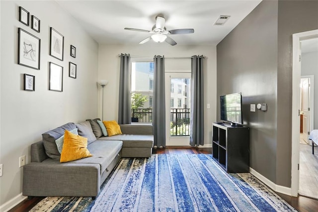 sitting room featuring dark wood-type flooring and ceiling fan