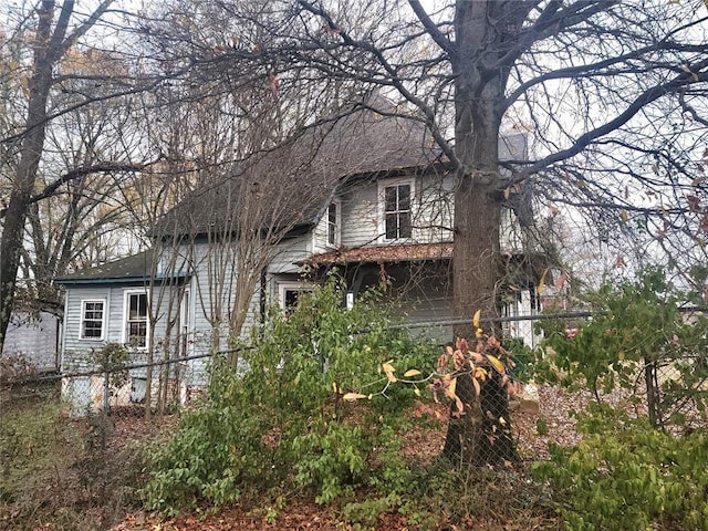 rear view of property with a garage