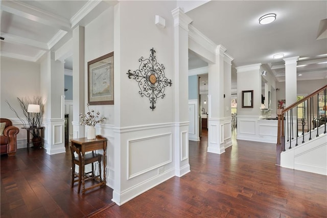 hall featuring a decorative wall, dark wood finished floors, decorative columns, stairs, and wainscoting