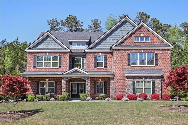 craftsman-style house with a front yard, brick siding, and french doors