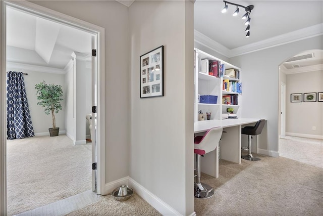 hallway featuring carpet flooring, crown molding, arched walkways, an office area, and baseboards