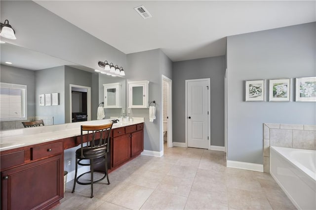 full bathroom with a garden tub, baseboards, double vanity, and tile patterned flooring