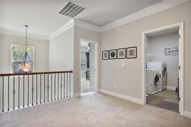 hallway featuring independent washer and dryer, crown molding, carpet, plenty of natural light, and baseboards
