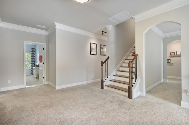 staircase featuring carpet flooring, crown molding, arched walkways, and baseboards