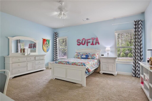 carpeted bedroom featuring a ceiling fan and baseboards