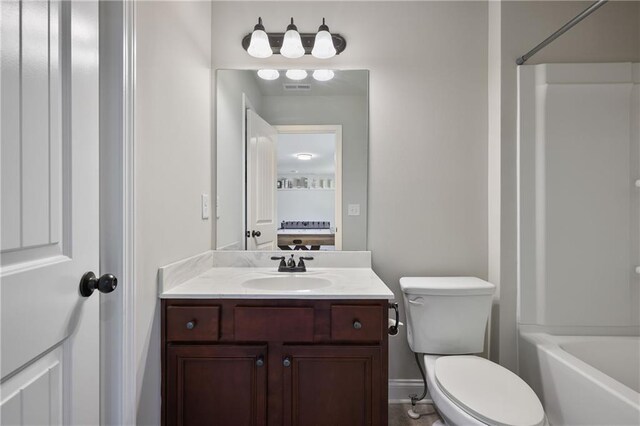 full bathroom featuring toilet, vanity, bathing tub / shower combination, and baseboards