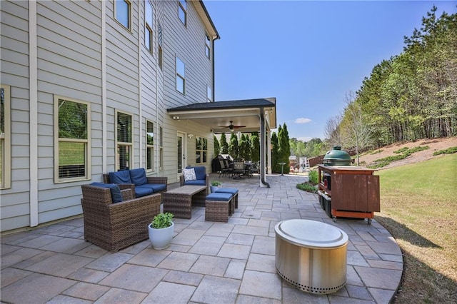 view of patio / terrace with an outdoor living space, ceiling fan, and outdoor dining space