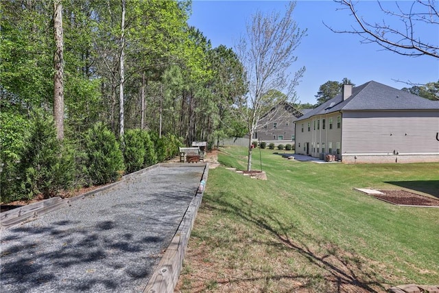 exterior space featuring a game area and a lawn