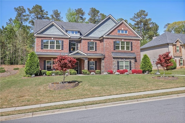 craftsman-style home with brick siding and a front lawn