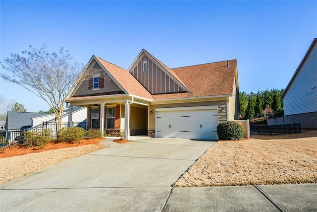 craftsman inspired home with board and batten siding, fence, a porch, a garage, and stone siding