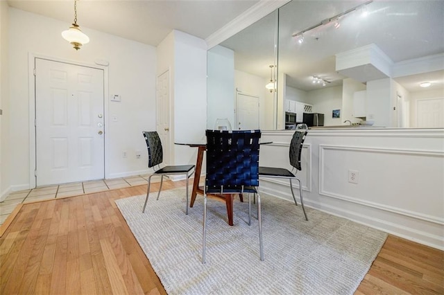 dining space with light wood-style floors and baseboards