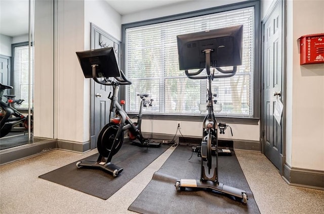 workout area with a wealth of natural light and baseboards