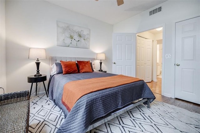 bedroom with lofted ceiling, baseboards, visible vents, and a ceiling fan