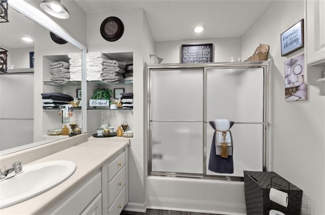 full bathroom with enclosed tub / shower combo and vanity