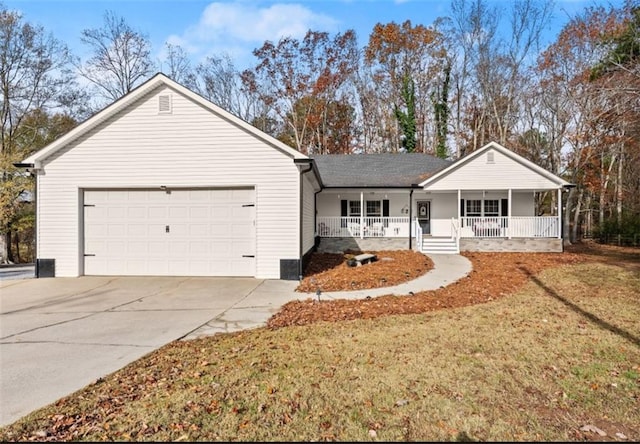 ranch-style house featuring covered porch, driveway, an attached garage, and a front yard